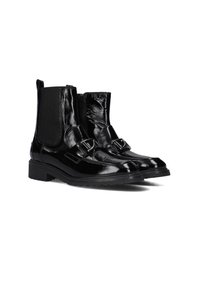 Black patent leather ankle boots with elastic side panels, two decorative straps with buckles, and a textured rubber sole.