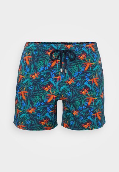 Μαγιό σορτσάκι με ναυτική βάση που διαθέτει ένα φωτεινό τροπικό λουλούδι σχέδιο σε κόκκινο, μπλε και πράσινο. Ζώνη με κορδόνι και επένδυση από δίχτυ.