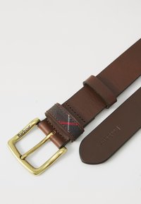 Brown leather belt with gold buckle and textile accent featuring a tartan pattern in red and grey. Includes embossed brand name, "Barbour".