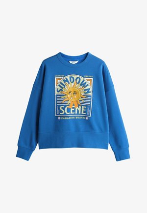 Blauer Pullover mit Grafik einer Sonne mit Gesicht, Text "Sundown Scene", "Mykonos Griechenland" und "Paradise Beach".