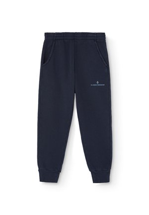 Navy blue sweatpants made of soft material, featuring an elastic waistband, two side pockets, and a small printed logo near the hip.