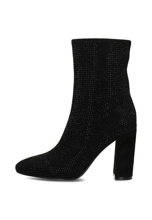 Botte noire à cheville avec un design cannelé texturé, un bout pointu et un talon épais. Le matériau semble doux et semblable à du daim, avec des embellissements subtils.