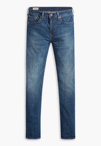 Jean en denim bleu coupe slim avec poches avant et arrière, fermeture par bouton, et légers effets délavés sur les cuisses et les genoux.