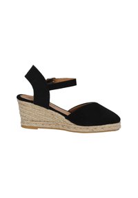 Scarpa con zeppa espadrille nera, con tomaia in tessuto e cinturino alla caviglia regolabile, e tacco rivestito in juta per aggiungere texture e altezza.