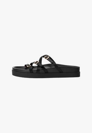 Black platform sandals with multiple crisscross straps and gold-tone buckles. Smooth synthetic material and rounded toe design.
