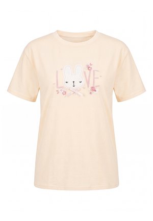 Cremefarvet t-shirt med korte ærmer, teksten “LOVE”, et sødt kaninansigt, lyserøde blomster, små hjerter og en sløjfe på brystet.