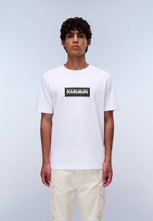 White cotton t-shirt with short sleeves, featuring a black logo print centered on the chest. The fit is relaxed, and the texture is smooth.