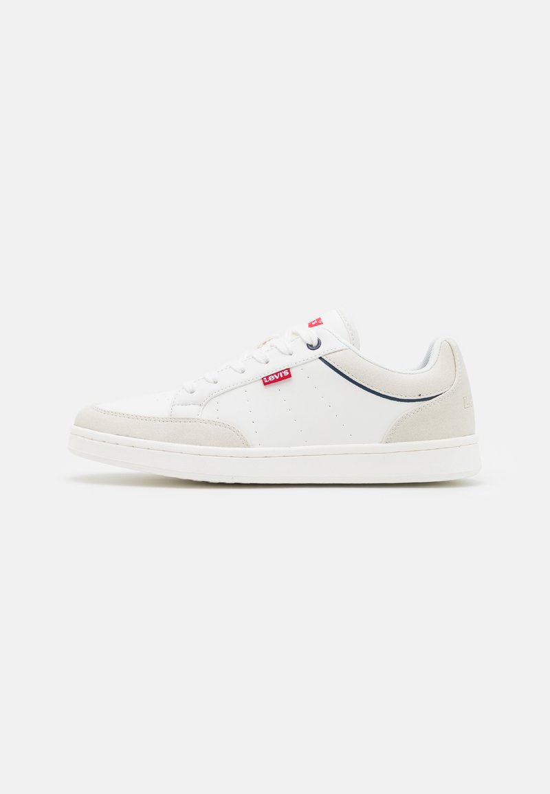 White sneakers with a smooth leather upper, suede accents in beige, perforated detailing, and a contrasting navy trim. Red brand logo on side.