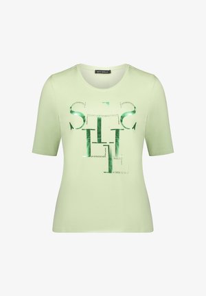 T-shirt vert clair à manches courtes en tissu doux, avec un imprimé graphique vert brillant contrastant sur le devant. Col rond, coupe ajustée.