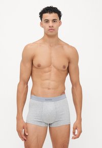 Boxer briefs Sloggi gris en tissu doux, avec une taille élastique portant le logo et un design ajusté.