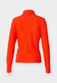 Langärmliges Oberteil in leuchtendem Orange mit geripptem Muster und schmalem Kragen. Verfügt über enganliegende Ärmel und einen geraden Saum.