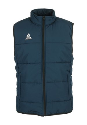 Dikke mouwloze vest in donkerblauw, met een hoge kraag, een ritssluiting aan de voorkant en een wit logo op de linkerborst. Gelaagd quiltontwerp.