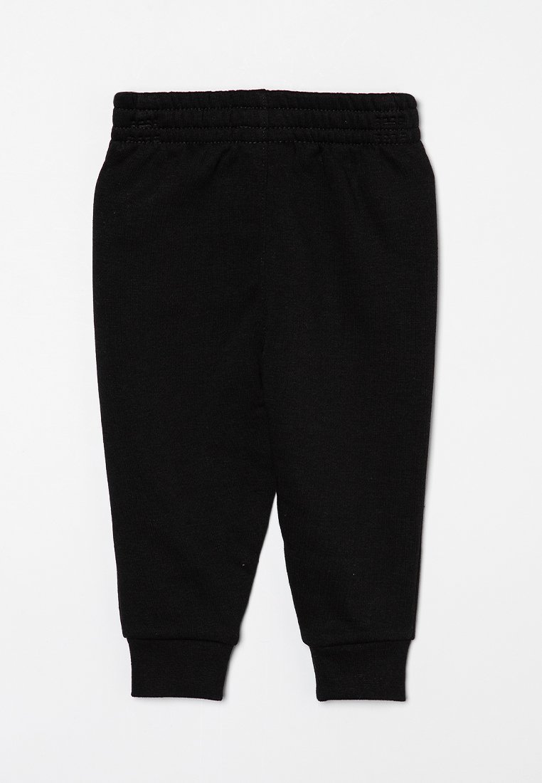 Pantalones de chándal de algodón negro con cintura elástica y tobillos ajustados; textura suave, diseño ajustado, sin patrones ni adornos.