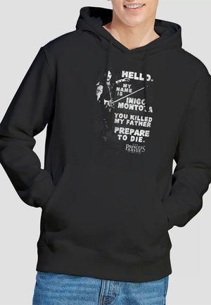 Schwarzer Hoodie mit einem grafischen Druck, der Text und eine Charakterillustration aus "Die Prinzessin Braut" zeigt. Material aus Baumwollmischung mit einer Fronttasche.