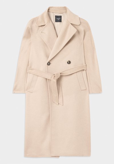 Beige wool blend coat with a double-breasted design, notched lapels, waist tie, and side pockets. Smooth texture and mid-length style.