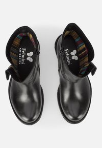 Black leather ankle boots with a rounded toe, featuring a zip closure and patterned fabric lining in shades of red, blue, and gold.