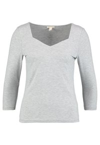 Helles graues Langarm-T-Shirt mit V-Ausschnitt. Hergestellt aus weichem, dehnbarem Material, mit einer enganliegenden Passform und einer glatten Textur.