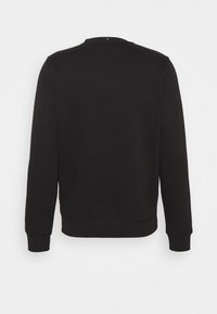 Sweat-shirt noir à manches longues et col rond, présenté de dos avec des poignets et un bas côtelés sur un fond uni.