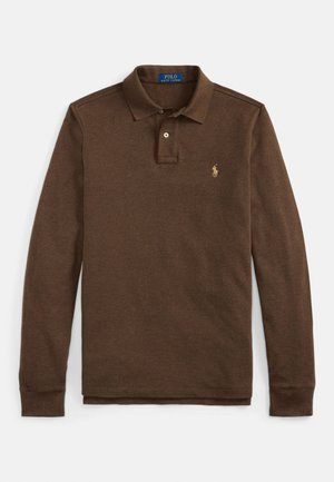 Hnedé polo tričko s dlhými rukávmi z mäkkej tkaniny, s troch gombíkovou légou a vyšívaným zlatým logom na ľavej strane hrude.