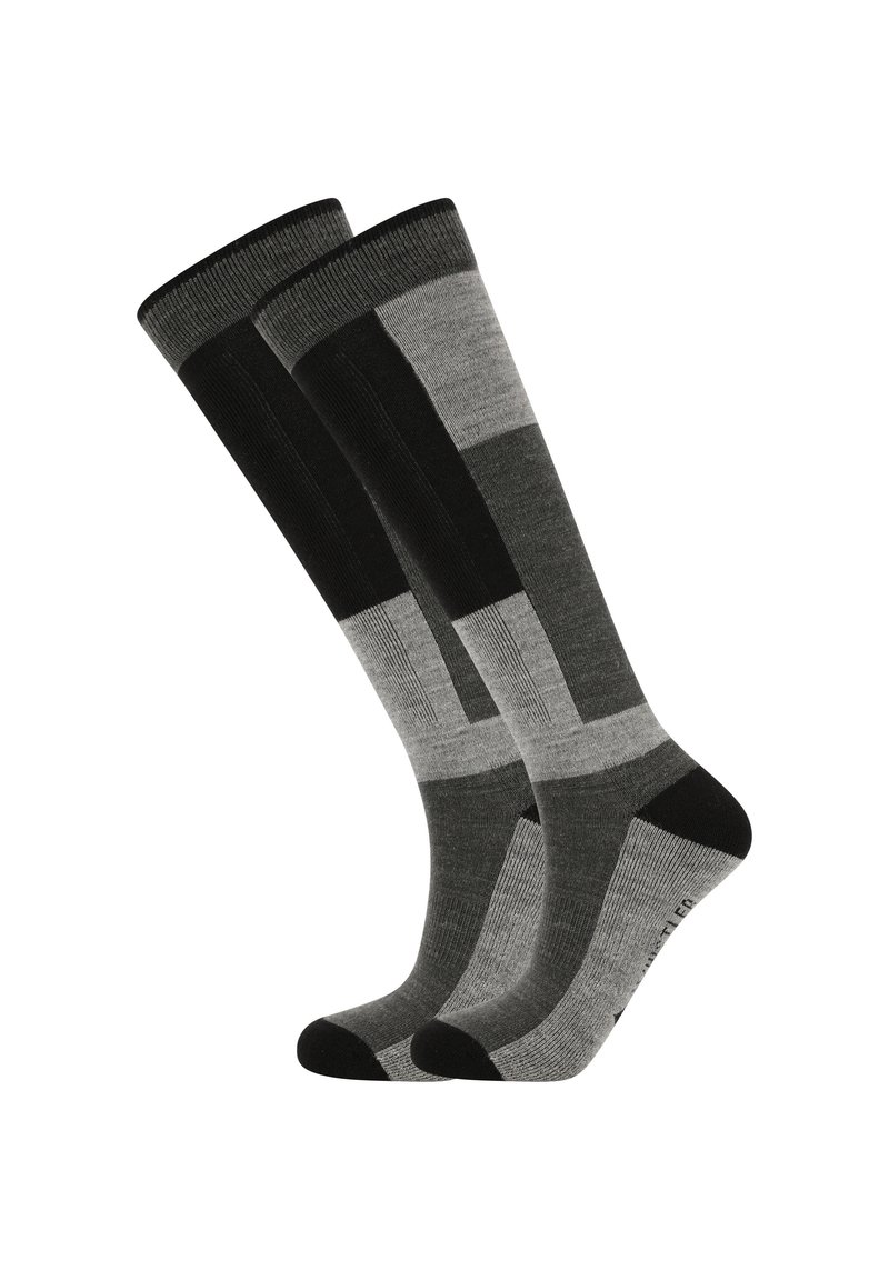 Chaussettes jusqu'aux genoux avec un motif géométrique dans des nuances variées de noir et de gris, fabriquées à partir d'un tissu doux et texturé avec des accents noirs unis.