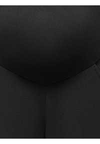 Svarte høytlivsleggings laget av glatt, elastisk stoff, med en sømløs design og subtil tekstur.