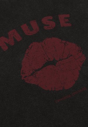 Svart tyg med djärv röd tryck av ordet "MUSE" och ett röd läppstiftskyssmärke, med en texturerad, något sliten yta.