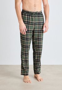 Gröna och svarta rutiga pyjamasbyxor med elastisk midja och snörning, med en mjuk tygtextur och smal design på benen.