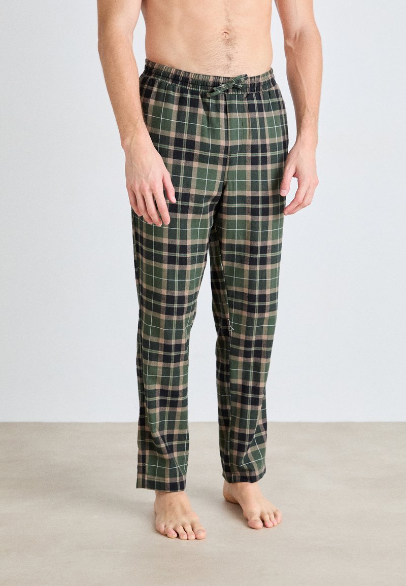 Gröna och svarta rutiga pyjamasbyxor med elastisk midja och snörning, med en mjuk tygtextur och smal design på benen.