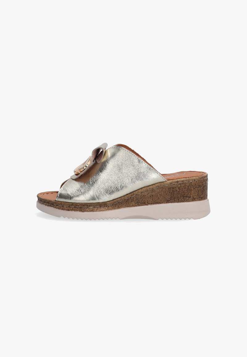 Wedge sandal with a metallic silver upper, peep-toe design, faux cork midsole, and textured rubber outsole. Features a decorative flower detail.