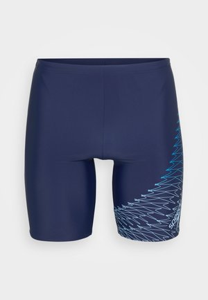 Shorts de bain bleu marine en tissu extensible, avec un motif zigzag bleu clair contrasté sur le côté droit.