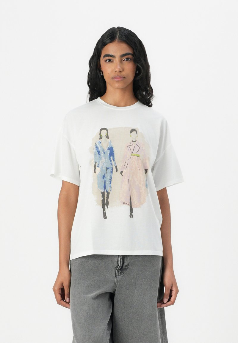White oversized t-shirt featuring a printed illustration of two figures. Short sleeves, soft fabric, and a relaxed fit.