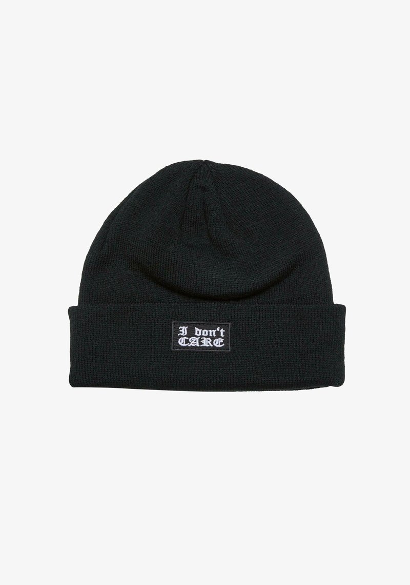 Black knit beanie with a ribbed texture and a folded cuff, featuring a rectangular patch that displays the text "I don't CARE" in white.