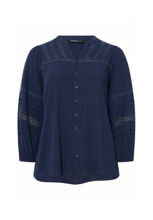 Marineblaue langärmelige Bluse mit Knopfleiste vorne, Spitzeinsätzen an Schultern und Ärmeln sowie gerafften Ärmelbündchen.