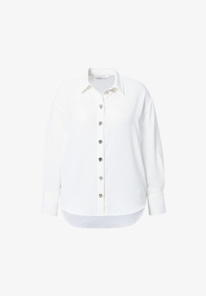 Biała, długi rękaw, koszula zapinana na guziki z ozdobnymi, srebrnymi guzikami w kształcie serca z przodu oraz zaokrąglonym dołem.
