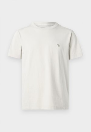 Kurzarm-T-Shirt aus leichtem beige Baumwollstoff, mit kleinem gestickten Hirsch-Logo auf der linken Brust. Rundhalsausschnitt mit normaler Passform.