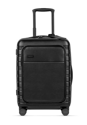 Black hardshell suitcase with a textured surface, retractable handle, and four wheels. Features a front pocket and sleek design.