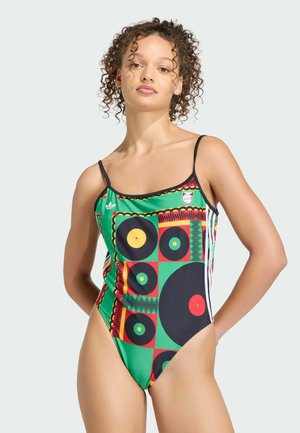 Costume intero con motivo vivace a dischi verdi, rossi e neri, spalline regolabili e design a gamba alta.