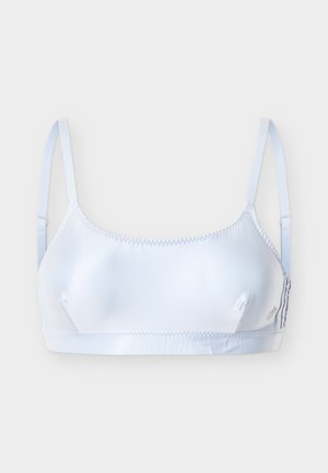 Soutien-gorge sans couture blanc avec bretelles fines réglables et tissu doux, conçu pour un soutien léger et un confort optimal.