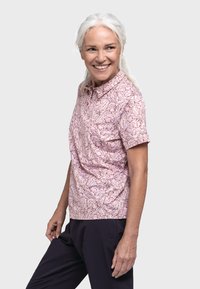 Kurzärmliges Polohemd in Rosa mit floralem Muster, ausgestattet mit Kragen, Knopfleiste und entspanntem Schnitt. Hergestellt aus leichtem Stoff.