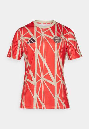 Red sports jersey featuring a geometric light tan pattern, short sleeves, round neckline, and FC Bayern München logo on the chest.