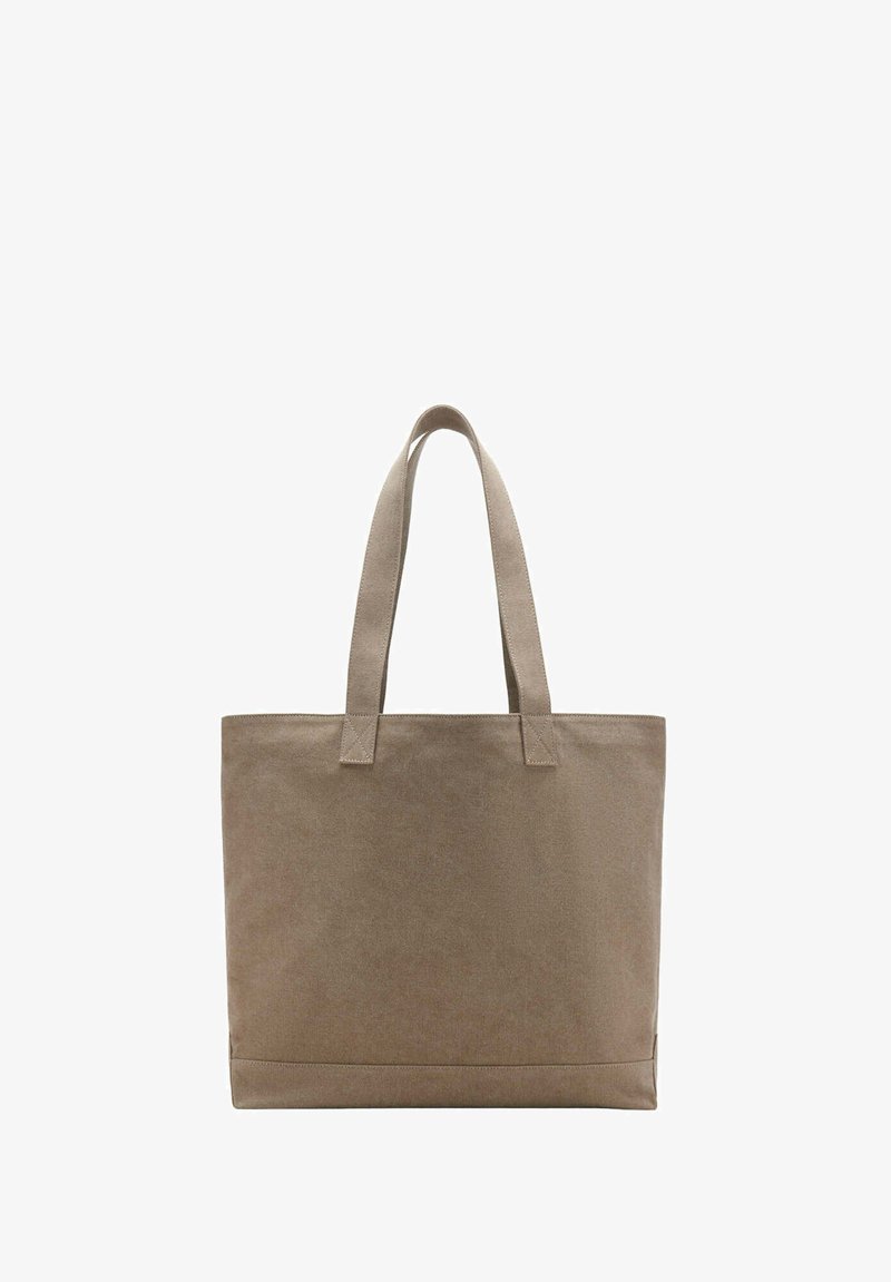Sac fourre-tout en toile beige uni avec deux bretelles, forme rectangulaire et coutures visibles sur fond blanc.