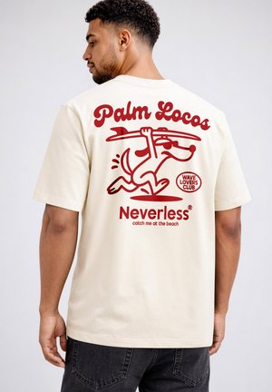 Man seen from behind wearing cream T-shirt with red cartoon dog carrying surfboard and text "Palm Locos," "Neverless," and "Wave Lovers Club."