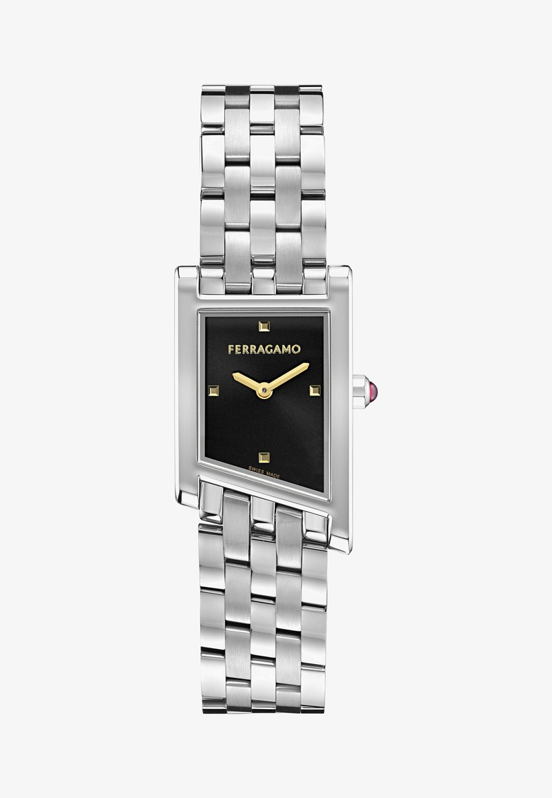 Hõbedane roostevabast terasest kell, millel on ristkülikukujuline must kelladial, kuldsed tundemarkerid ja tekstuuriga link-nöör. Omab kalliskivi aktsenti kroonil.