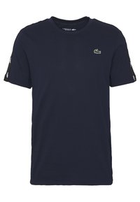 Navy blue cotton t-shirt with a crew neck, short sleeves, and Lacoste logo embroidery on the chest and sleeve accents.