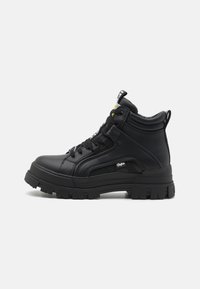Black high-top footwear made of textured leather, featuring a thick rubber sole, lace-up front, and a small logo detail on the side.