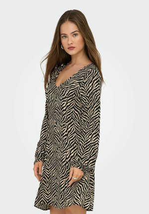 Animal print dress in beige and black with a V-neck, long sleeves, and a loose fit. Features a flowing design and soft texture.