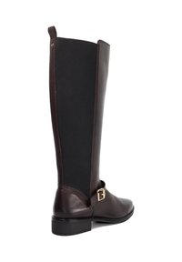 Brown leather knee-high boot with a black elastic panel, a metallic buckle accent, and a flat sole design. Smooth texture, sleek silhouette.