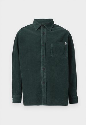 Dark green corduroy long-sleeve shirt with black buttons, a front chest pocket featuring a small white tag, and a classic collar.