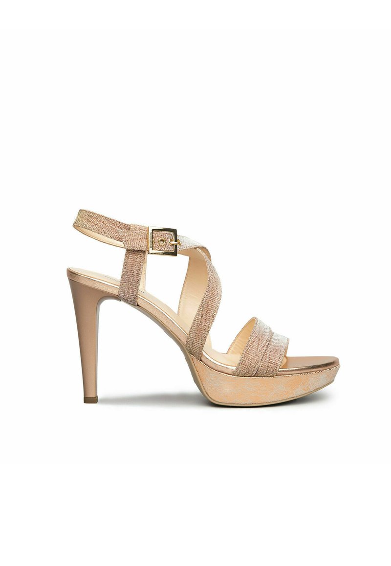 Beige high-heeled sandals with crisscross straps, textured fabric, an adjustable ankle buckle, and a platform sole.