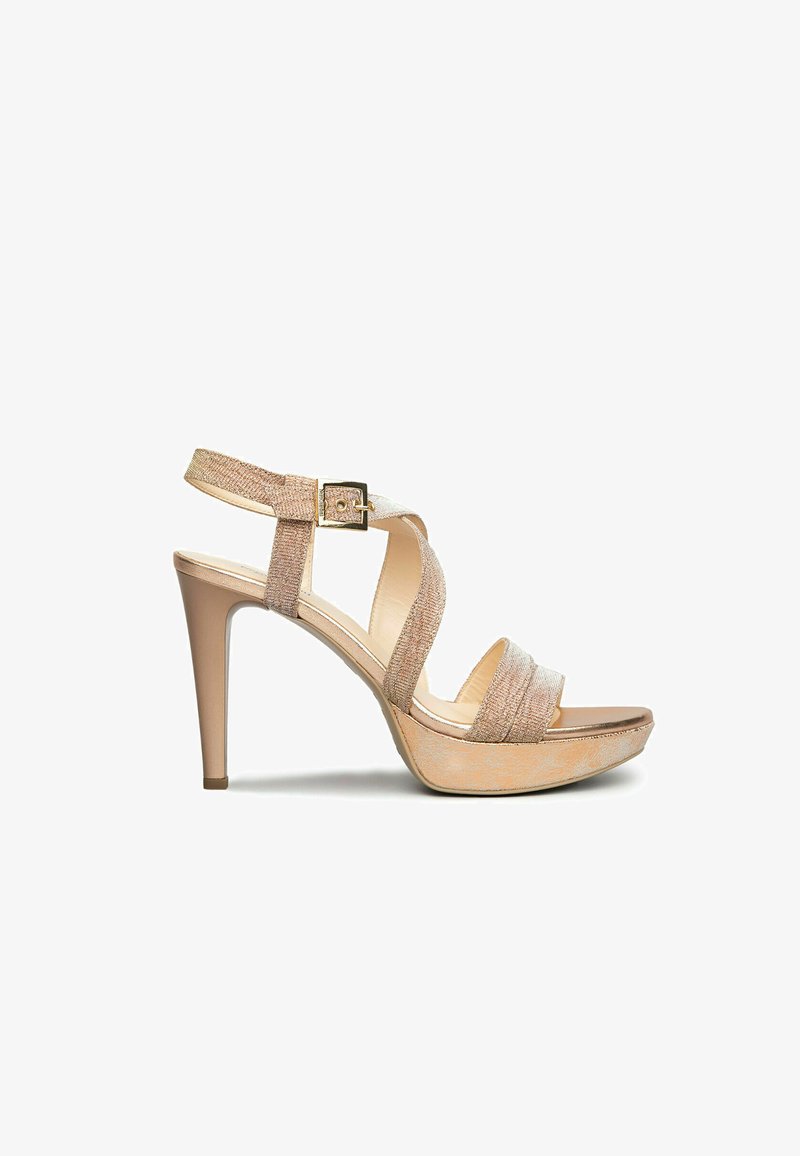 Beige high-heeled sandals with crisscross straps, textured fabric, an adjustable ankle buckle, and a platform sole.